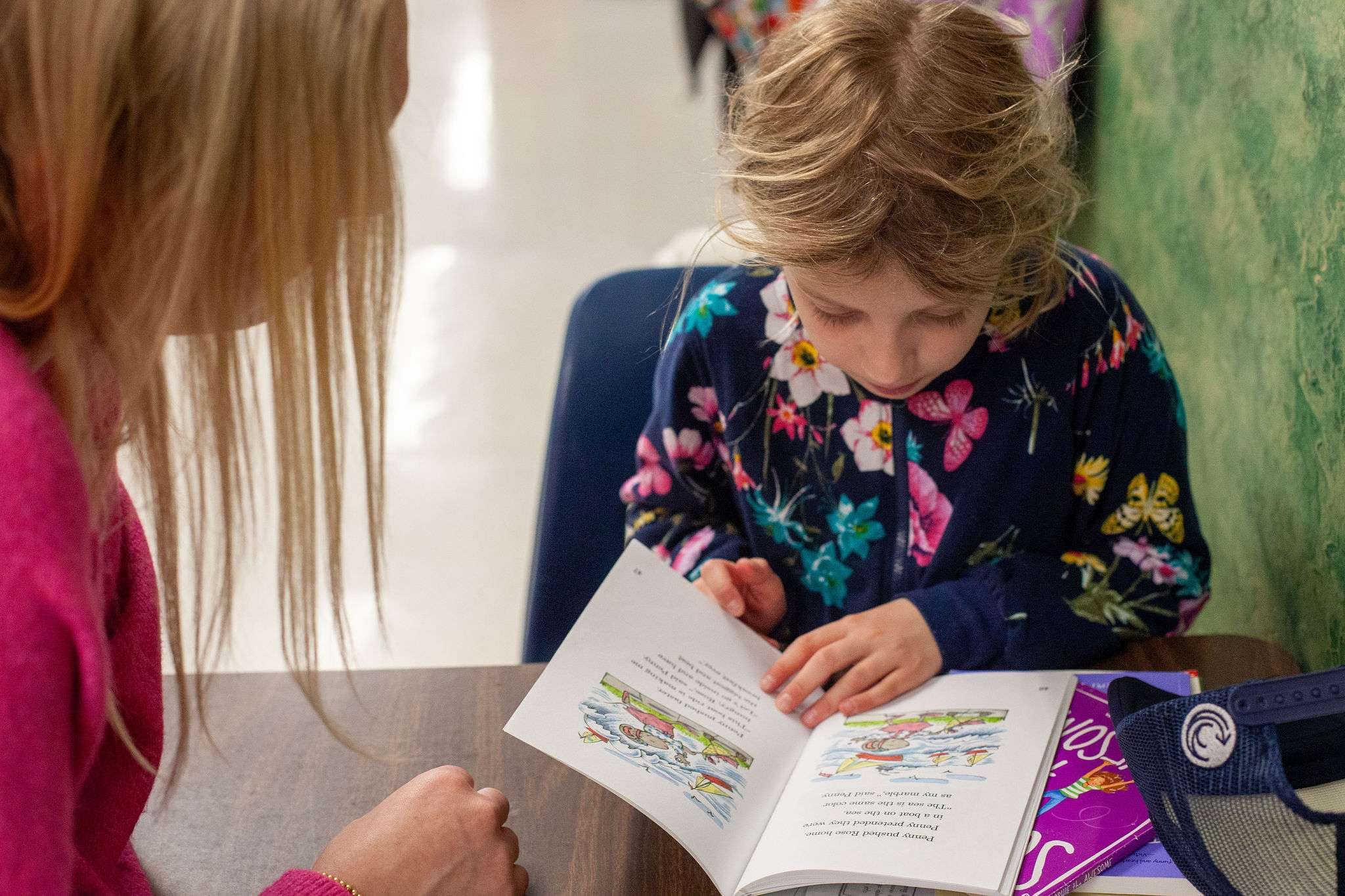 ROW volunteer and student reading together