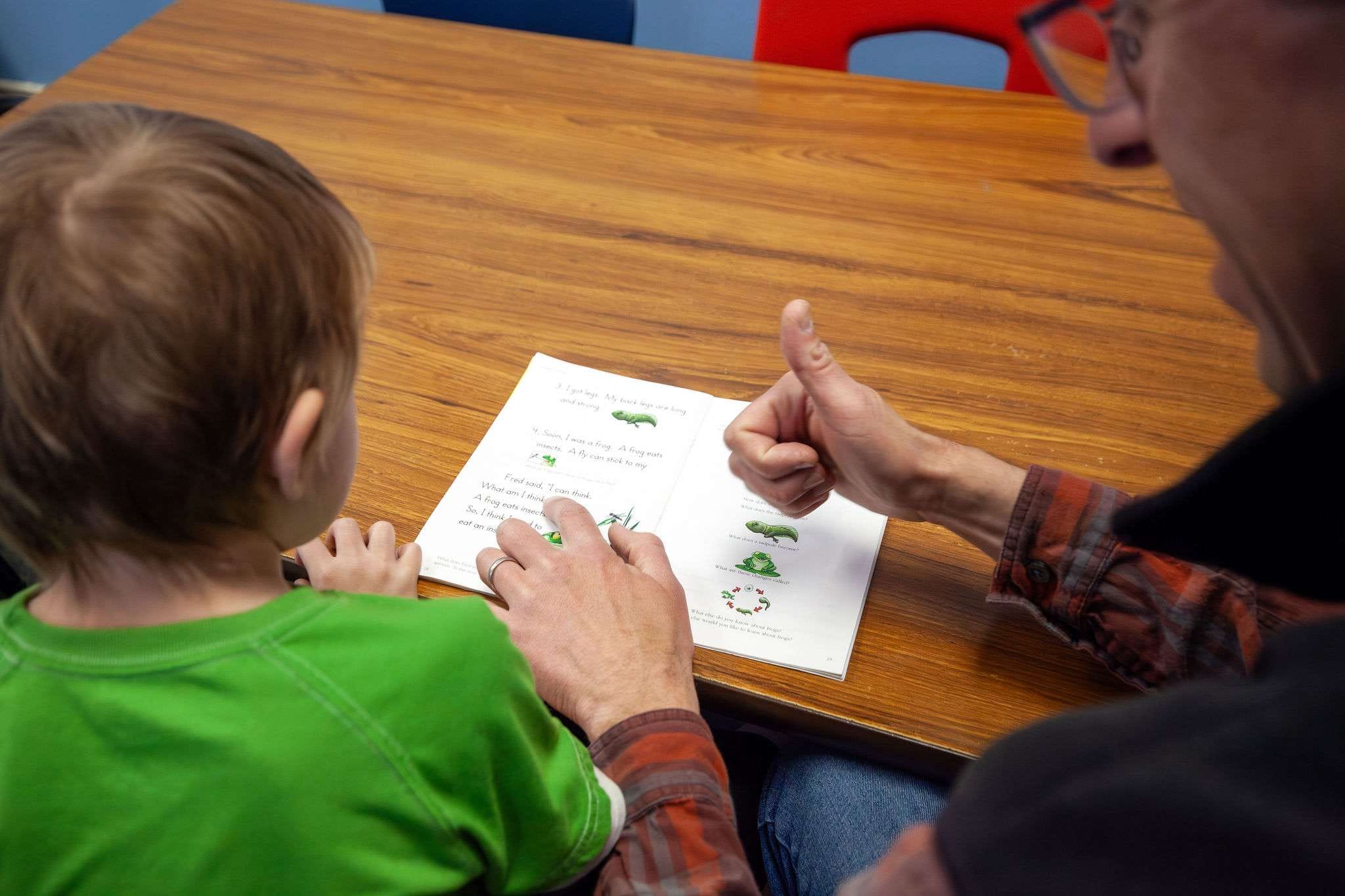 ROW volunteer reading with student