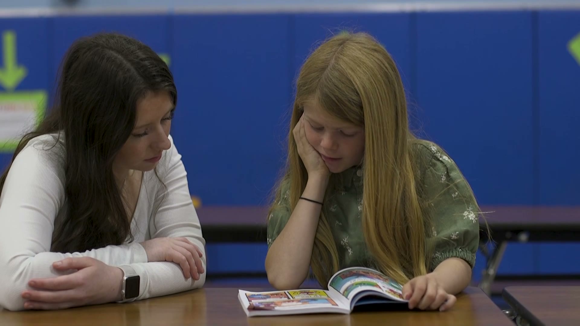 A ROW volunteer and student reading together