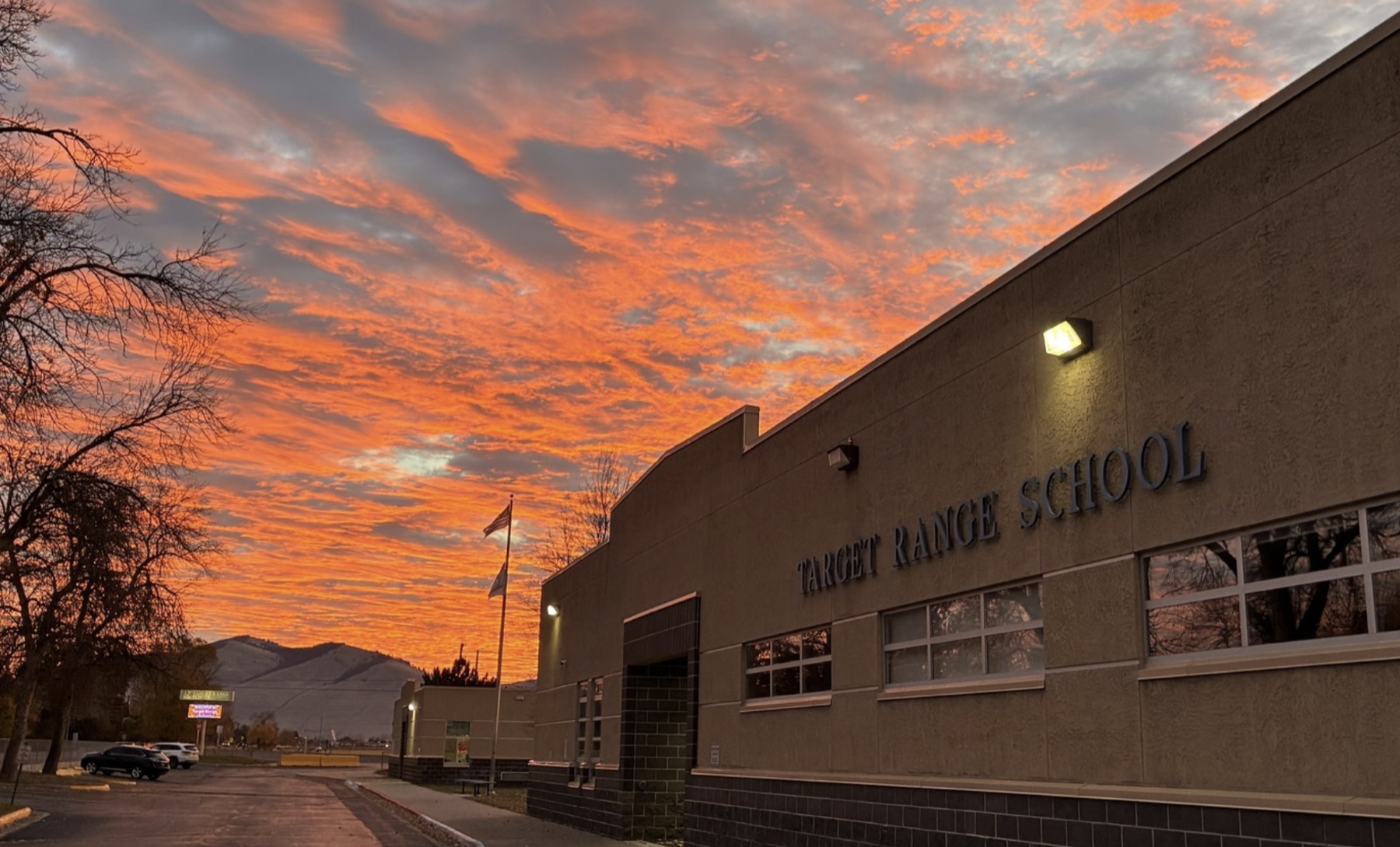 Target Range School beneath a vivid orange sunset
